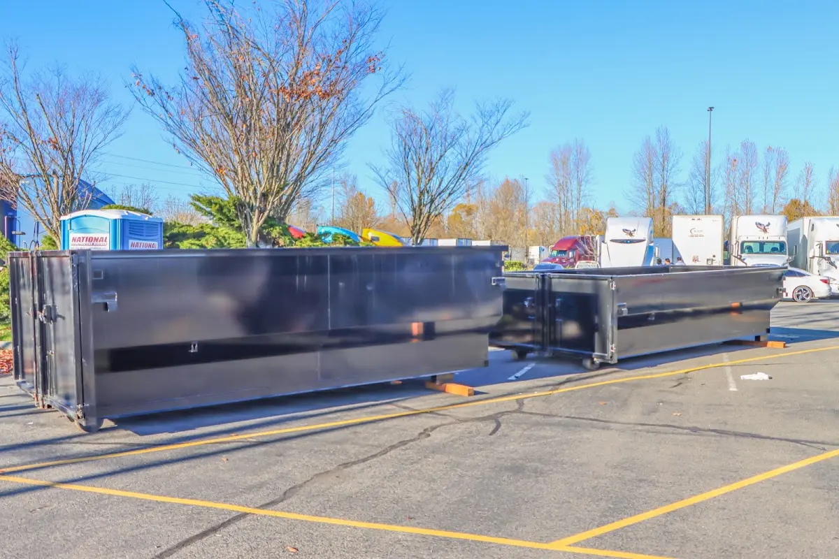 Professional dumpster rental service with roll-off container on residential driveway in Stratmoor